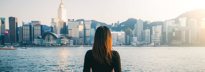 A girl overlooking Victoria Harbour, Hong Kong and contemplate about work