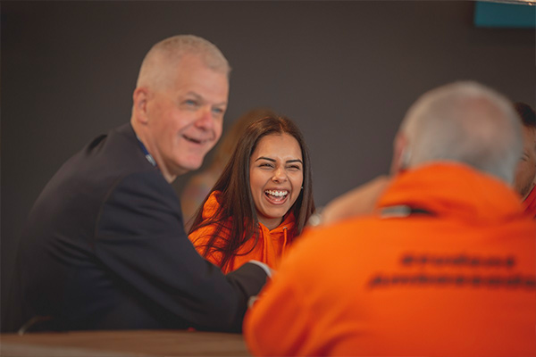 University of Sunderland's Vice-Chancellor and Chief Executive Sir David Bell chatting happily with students and staffer