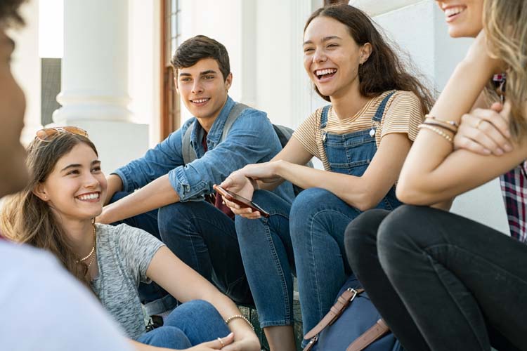 Students sitting in the campus and talking.