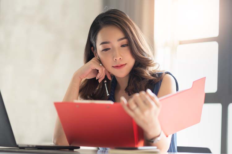 Asian female accountant working in the office.