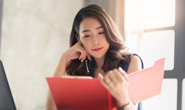 Asian female accountant working in the office.