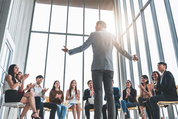 Business people clapping their hands during the meeting.