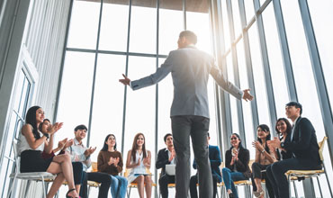 Business people clapping their hands during the meeting.