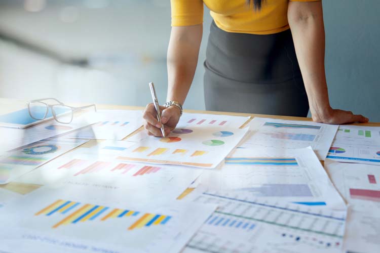 Female accountant checking report file.