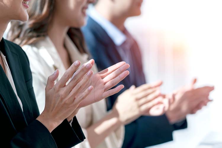 Group of business people clapping in row.