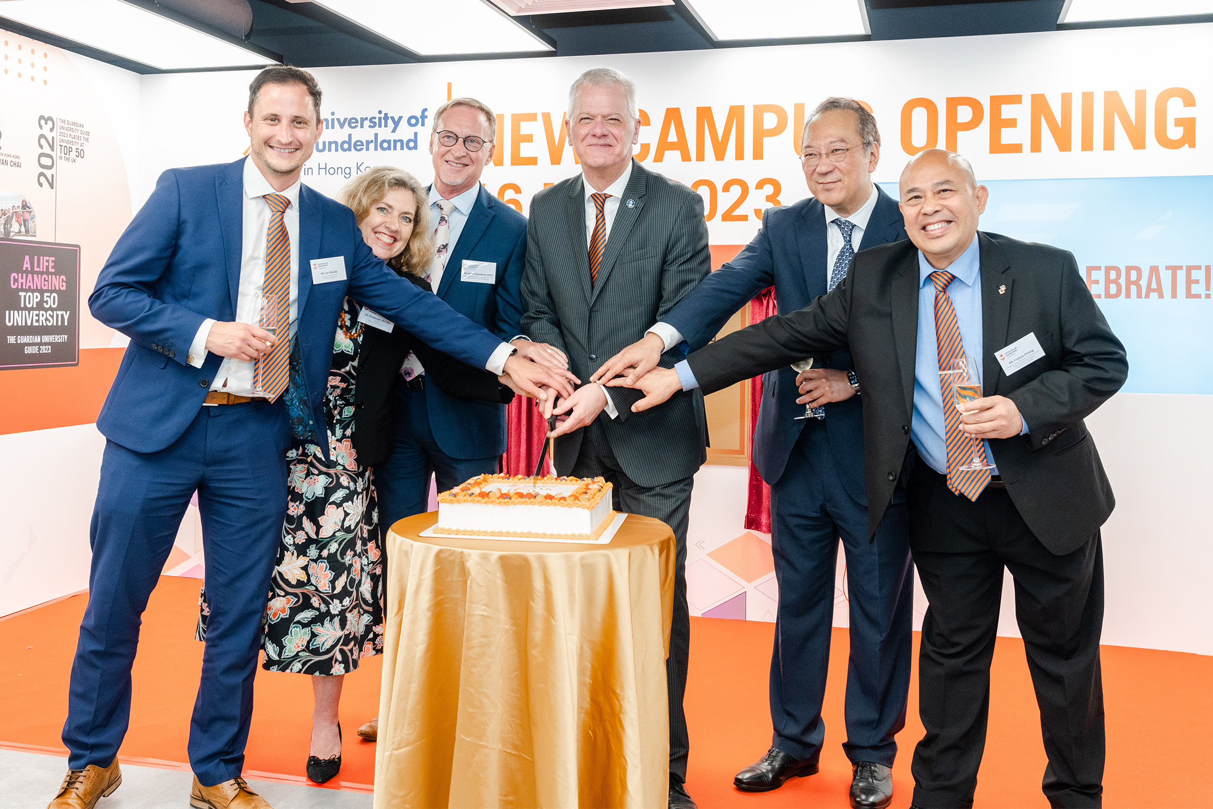 University of Sunderland staff and guests of honours were standing around a large cake to celebrate the 6th Anniversary of University of Sunderland in Hong Kong, during University of Sunderland in Hong Kong New Campus Opening 2023.
