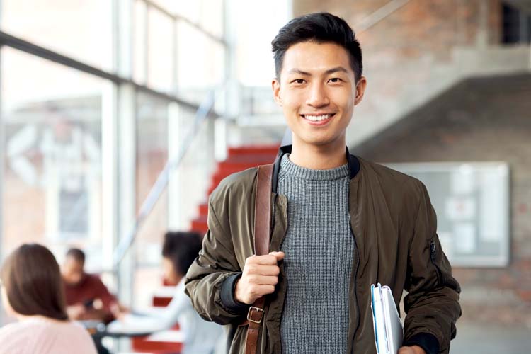 Asian man is happy to be accepted into an MBA programme to study and learn for his future.
