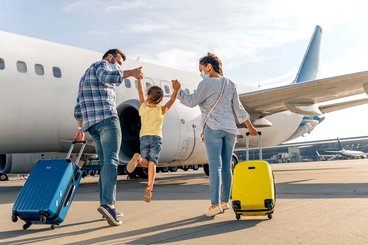 Happy family in masks enjoying travel together.