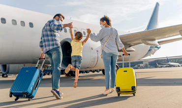 Happy family in masks enjoying travel together.