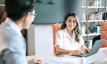 2 Asian Chinese white collar worker brainstorming in meeting room.