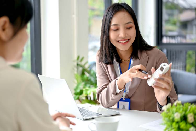 Asian female banker talking and planning an investment plan with a client.