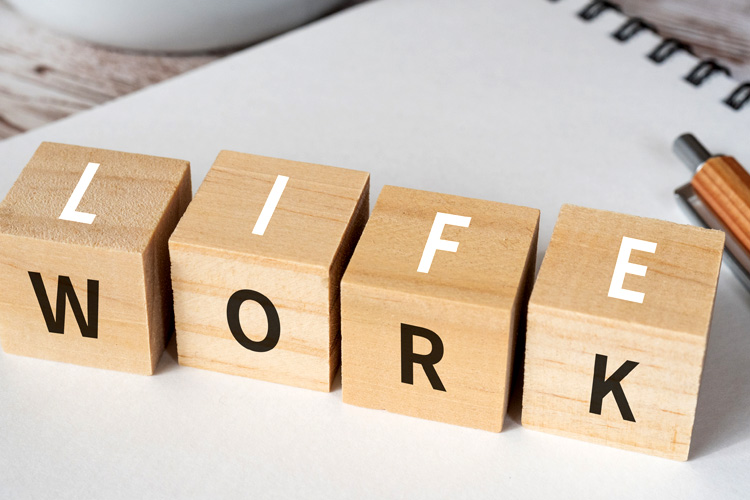 Wooden blocks with "LIFE" and "WORK" text of concept.