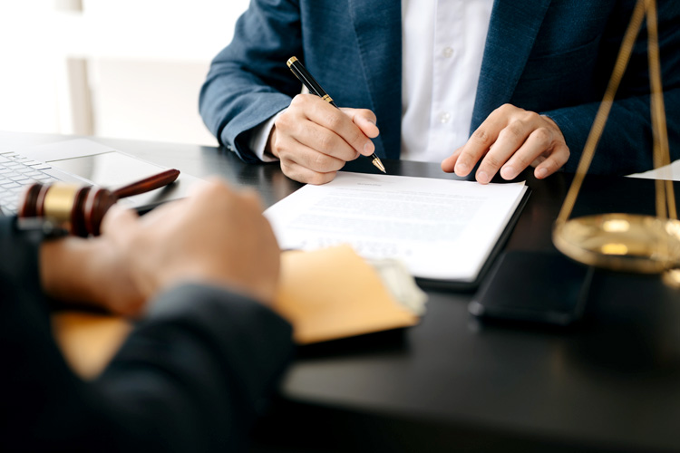 Two lawyers are discussing about contract paper on the table.