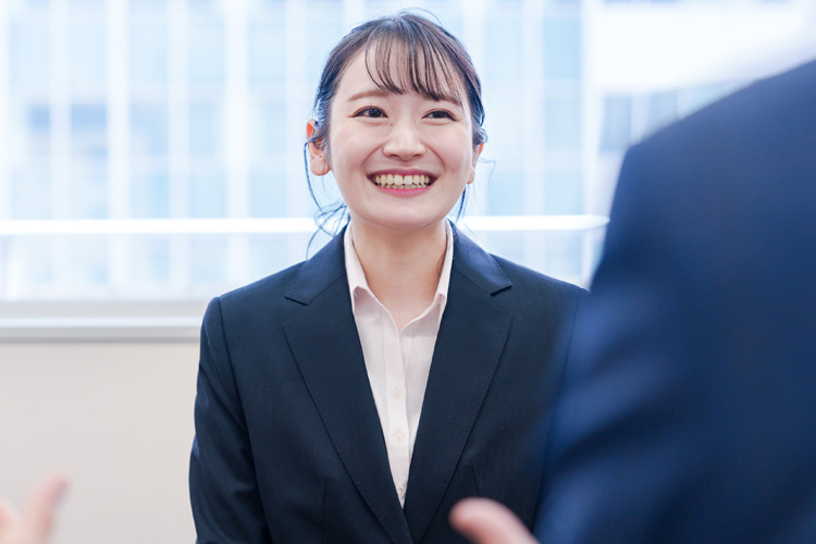 Female job hunter smiling during an interview.