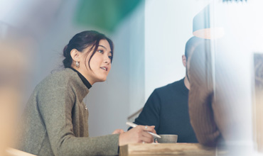 Employer interviewing a job applicant inside office boardroom.