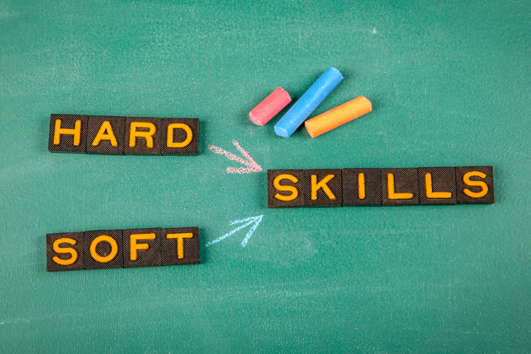 Soft Skills and Hard Skills Concept. Old letter tiles on a green chalkboard background.