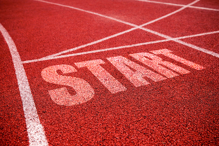 Starting line sign at running track background.