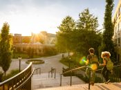 Two university students walk down campus stairs.
