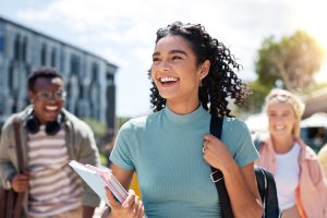 Happy girl with friends at university for learning, bonding and talking with fun.